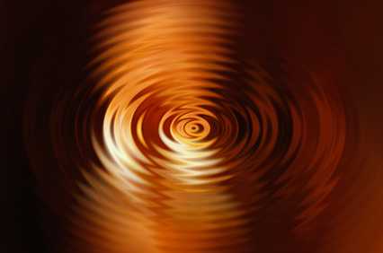 Goldene Wellen ziehen Kreise vor schwarzem Hintergrund - so wie die Schwingungen der Diamond Shield Zapper